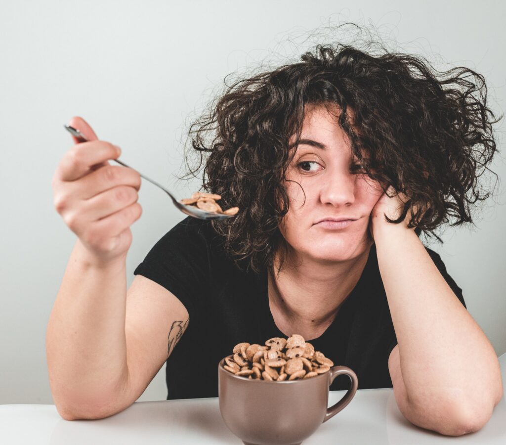 Woman eating sugary cereal when she's stressed out