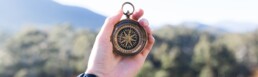 hand holding a compass
